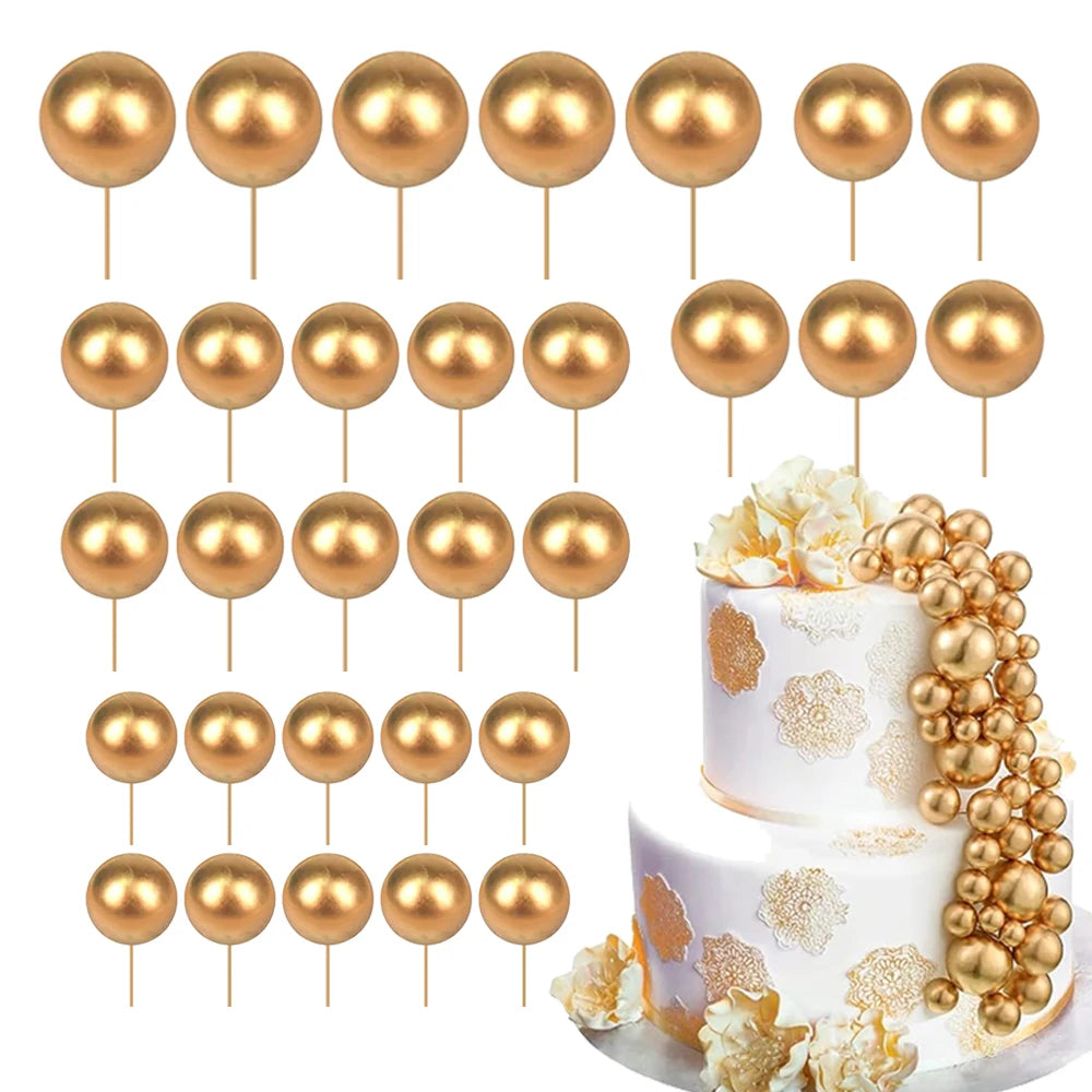 A set of gold and rose gold spherical foam cake toppers on sticks.
