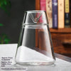 Clear glass multi-size decor vase with a pointed top sitting on a white surface.