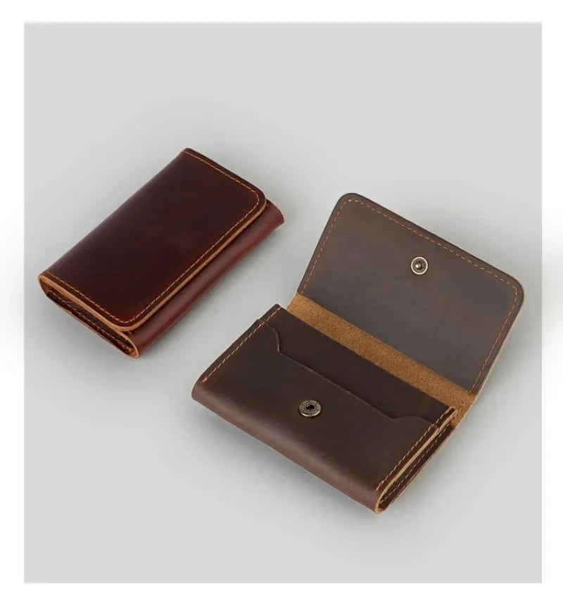 A dark brown vintage leather card holder and cable organizer shown from an angled view.