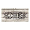 Rustic wooden hanging sign with the words Welcome Home carved into the wood.