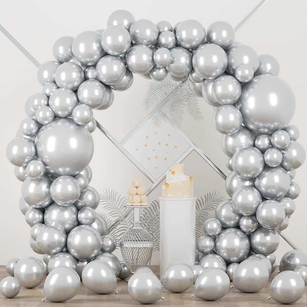 A large balloon garland arch made of metallic silver balloons with confetti accents.