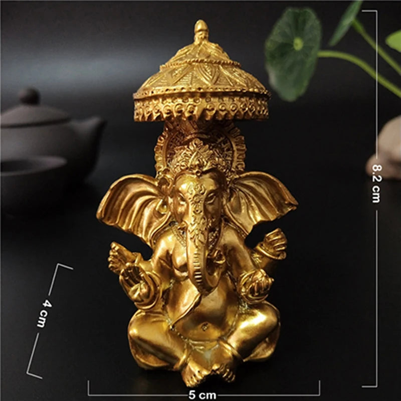 A golden bronze statue of Ganesha Buddha seated in a meditative pose, used for home decor.