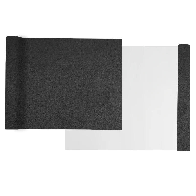 Black suede wrap fabric with a white sheet visible next to it for DIY projects