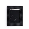 A black square film frame with a silver border and a recessed area for instant photos.