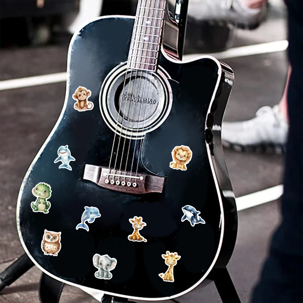 A black electric guitar features a decorative sticker pack of watercolor animal illustrations on its body.