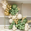 A display of green and gold confetti balloons arranged in a geometric frame.