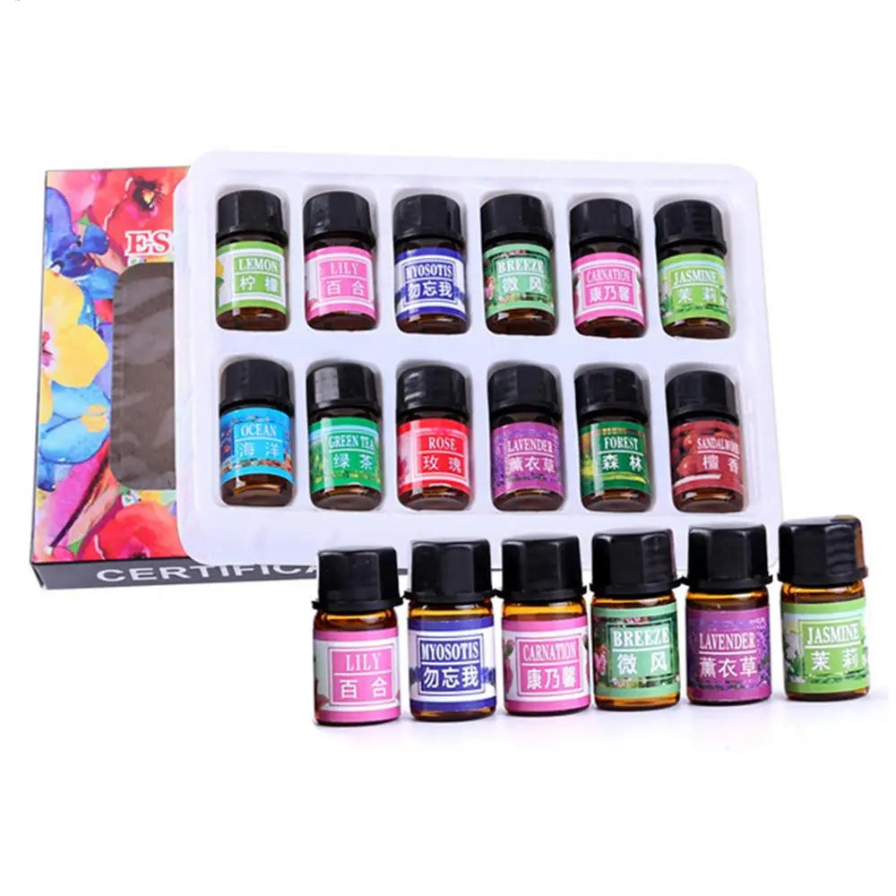 A set of 12 small glass bottles containing essential oils for aromatherapy and skin use, packaged in a white tray.
