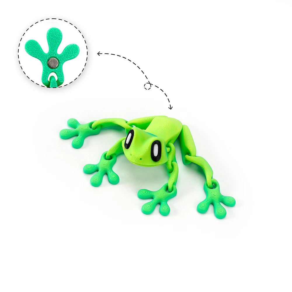A bright green articulated 3D printed frog magnet with movable limbs, shown next to its detached head.