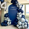 A balloon garland featuring metallic silver and navy blue balloons used for party decoration.