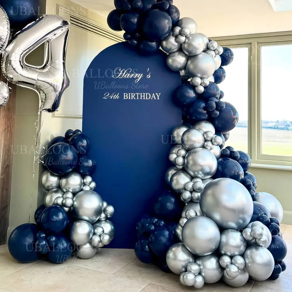 A balloon garland featuring metallic silver and navy blue balloons used for party decoration.