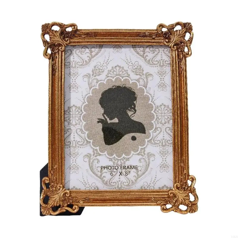An elegant gold-framed photo frame with a white background and vintage lace pattern.