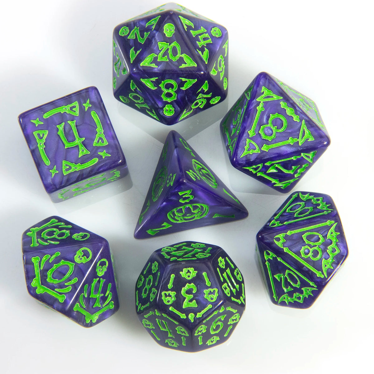 A set of seven polyhedral dice in various shades of purple and green resting on a white surface.