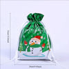 Reusable green and white Christmas drawstring gift bag with a snowflake design