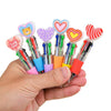 A hand holds a set of four heart-shaped multicolor ballpoint pens with various colored bodies and decorative tips.