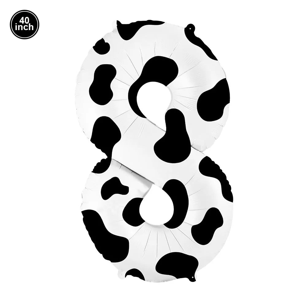 A white foil balloon shaped like the number 8 with a black cow print pattern.