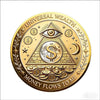 A round gold coin featuring an eye design and text that reads Universal Wealth and Money Flows to Me