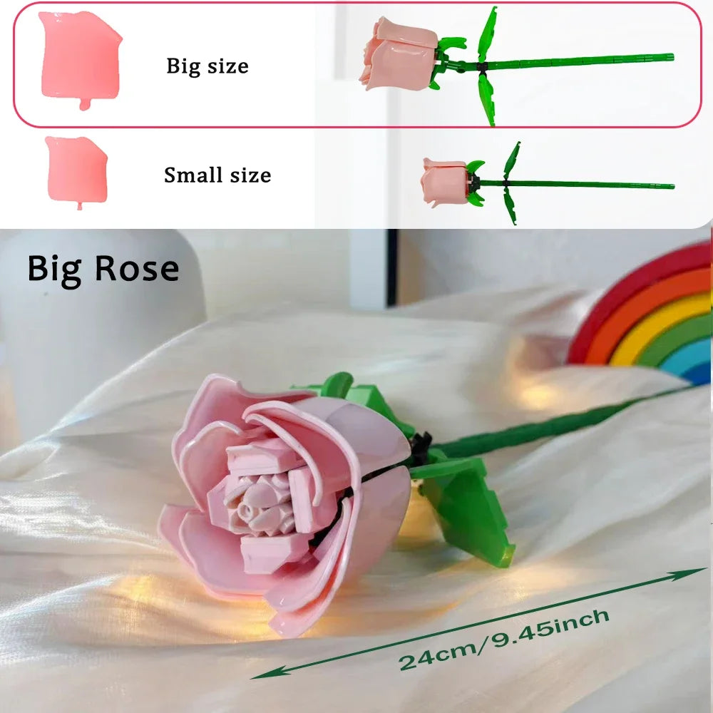 A pink rose flower made from building blocks is shown on a white cloth with a measurement line.