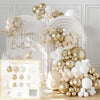 A golden and white latex balloon arch display featuring balloons and floral accents.