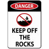 A vintage red and white warning sign that says DANGER and KEEP OFF THE ROCKS.