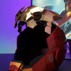 A close-up of the Iron Man MK5 wearable helmet in red and gold, displayed against a blurred background.