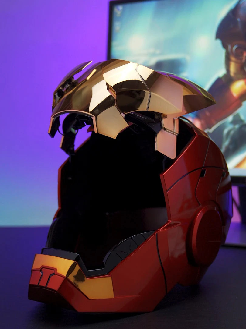 A close-up of the Iron Man MK5 wearable helmet in red and gold, displayed against a blurred background.