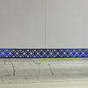 Blue decorative edge and corner trim applied to a white marble surface.
