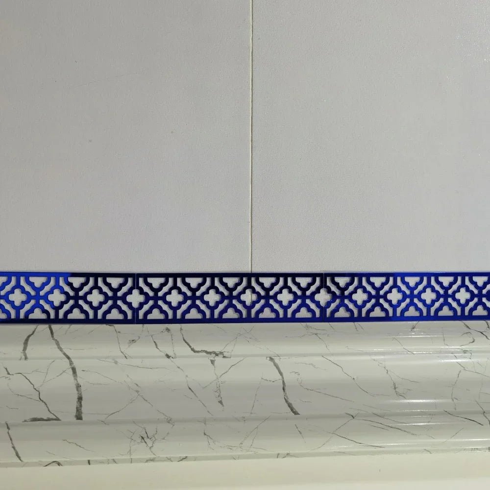 Blue decorative edge and corner trim applied to a white marble surface.