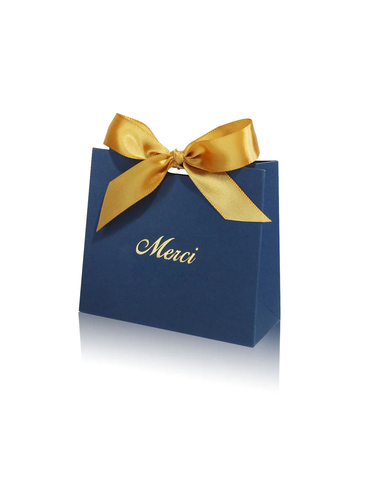 A dark blue paperboard gift bag tied with a golden ribbon, featuring the word Merci printed on the front.