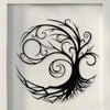 Black silhouette of a stylized tree with intricate branches and swirling leaves on a white wall.