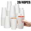 A stack of 20 disposable white paper coffee cups is shown, with one cup being held by a hand.