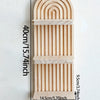 A vertical wooden wall shelf with a curved, ribbed design, measuring 40cm high and 14.5cm wide.