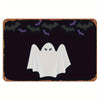 A dark metal tin sign featuring a white ghost silhouette against a black background with small purple bats.