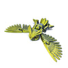 A yellow green articulated 3D printed owl figurine with spread wings, used as desk decor.