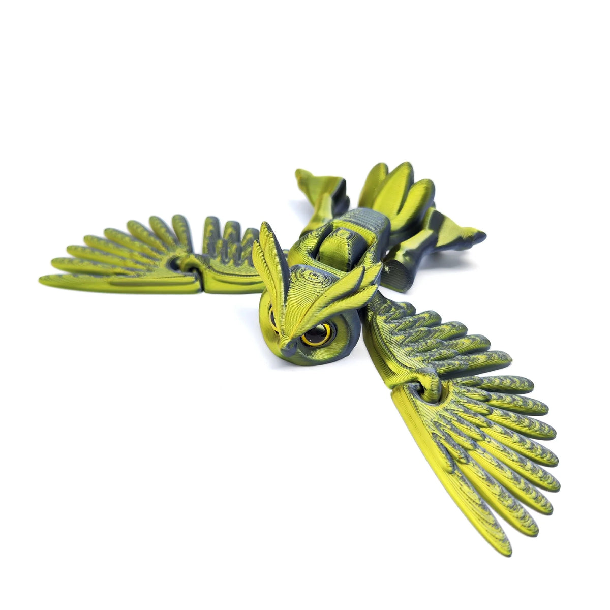 A yellow green articulated 3D printed owl figurine with spread wings, used as desk decor.