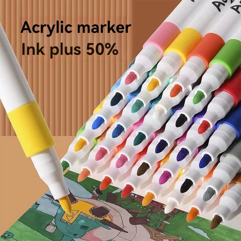 A close-up view of a set of 80-color acrylic markers with tips, laid out on an art surface.