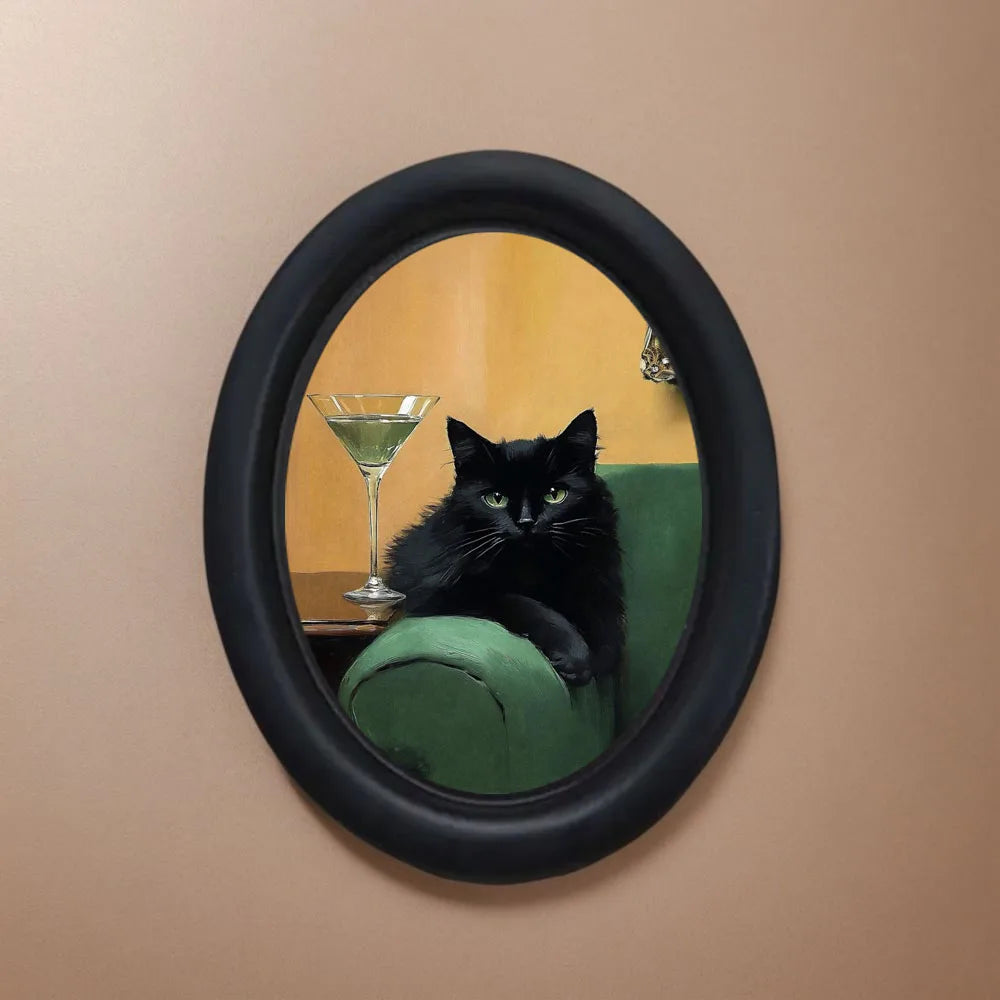 Oil painting of a black cat sitting on a green velvet chair within an oval frame.