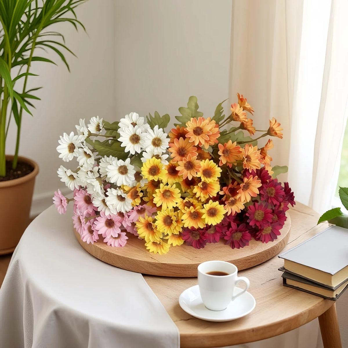 A wooden platter holds a vibrant arrangement of silk gerbera daisy artificial flowers in shades of white, yellow, orange, and