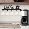Black wall-mounted coffee mug rack with heart hooks displaying white mugs above a wooden countertop.