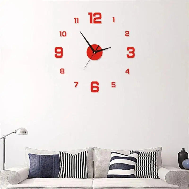 A red analog wall clock with black hands and numbers is mounted on a white wall above a sofa.