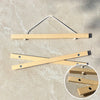Natural teak wood magnetic poster frame for wall art display with a metal hanger and wooden pieces.