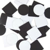 A scattered collection of black and white square and circular magnetic photo pieces.