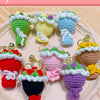 A collection of handmade crochet flower bouquets in various colors and textures, displayed on a light pink surface.
