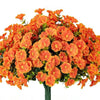 A dense arrangement of bright orange artificial morning glory flowers and green eucalyptus stems.