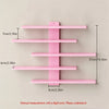 A pink set of four floating wall shelves with various lengths and mounting brackets.