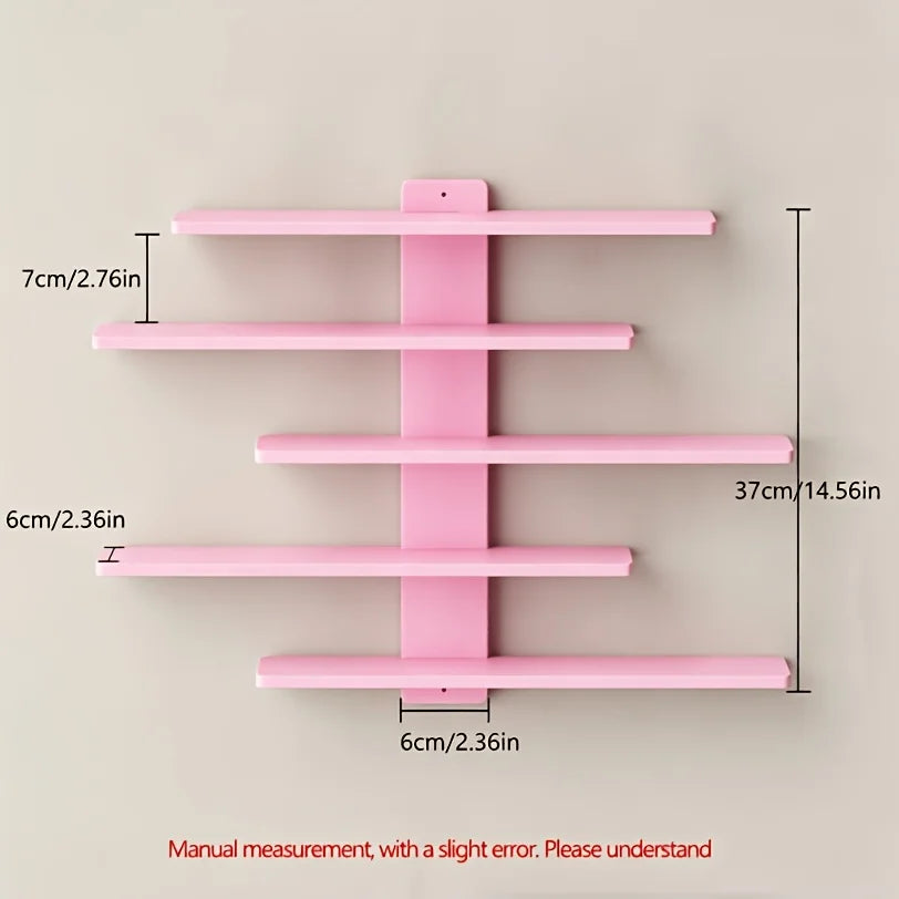 A pink set of four floating wall shelves with various lengths and mounting brackets.