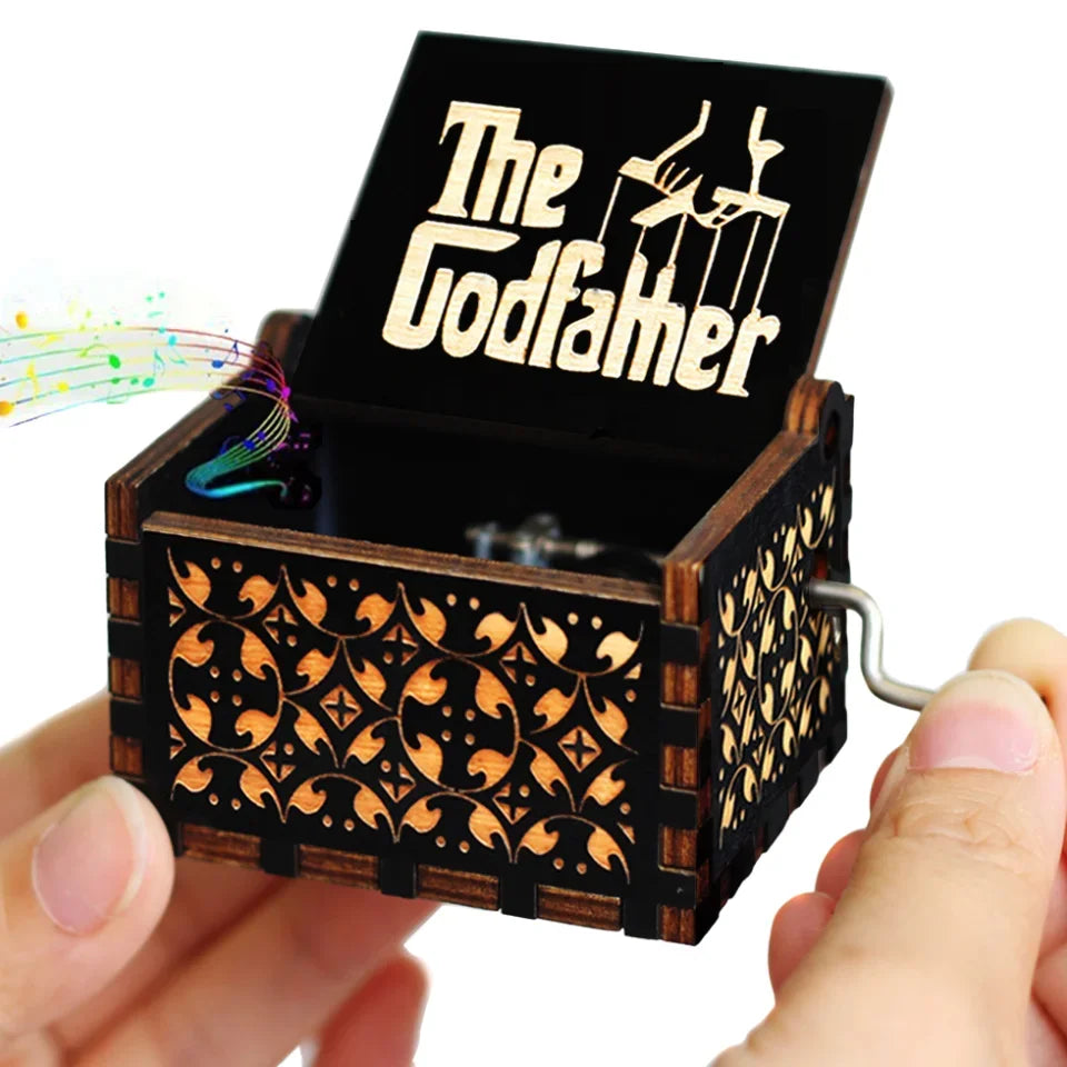 A carved wooden music box with an open lid revealing a silhouette of a figure and musical notes.
