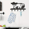 Black decorative metal key hooks mounted on a wall, with a blue patterned cloth hanging below.