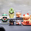 A collection of solar-powered waving lucky cat figurines in various colors and designs displayed on a dark surface.