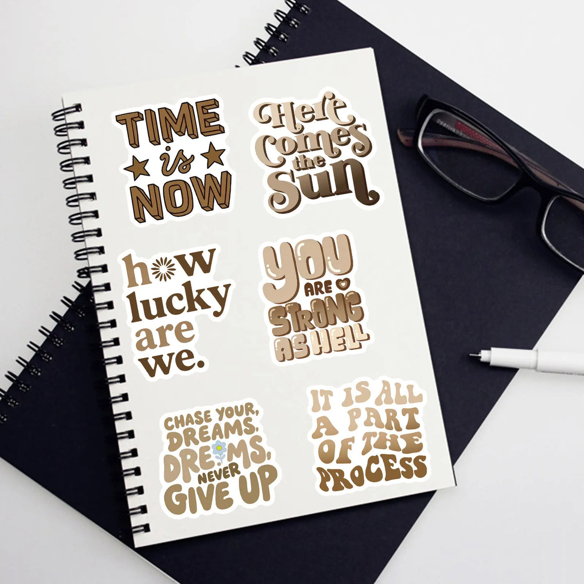 A page of motivational quote stickers featuring phrases like Time is Now and You are strong as hell.