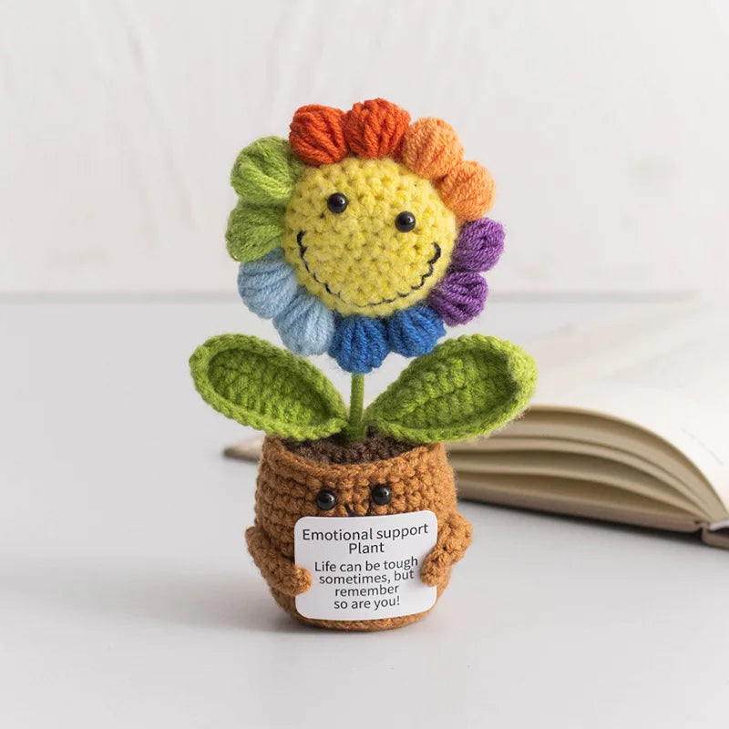 Handmade crochet sunflower desk companion with a smiling face featuring yellow, orange, and blue petals.
